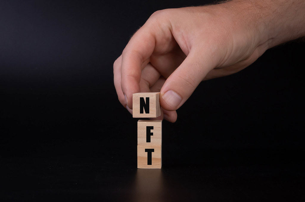 nft cubes held in hand showing expensive nft